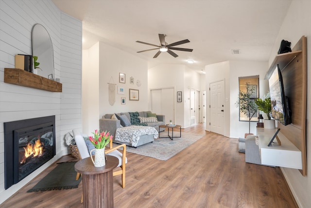 6624 Conrad Ave NW, Albuquerque, NM 87120 - living room with visible vents, baseboards, wood finished floors, a large fireplace, and ceiling fan