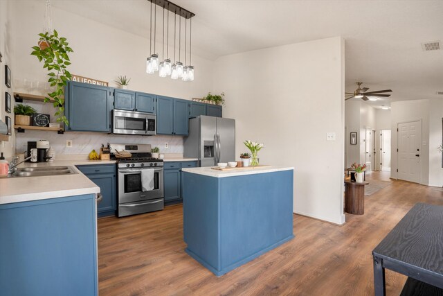 6624 Conrad Ave NW, Albuquerque, NM 87120 - kitchen featuring open shelves, a sink, light countertops, blue cabinetry, and appliances with stainless steel finishes