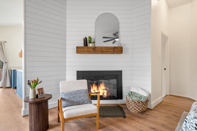 6624 Conrad Ave NW, Albuquerque, NM 87120 - sitting room with ceiling fan, a glass covered fireplace, and wood finished floors