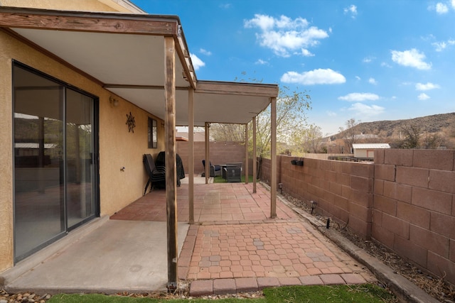 6624 Conrad Ave NW, Albuquerque, NM 87120 - view of patio featuring a fenced backyard and a mountain view