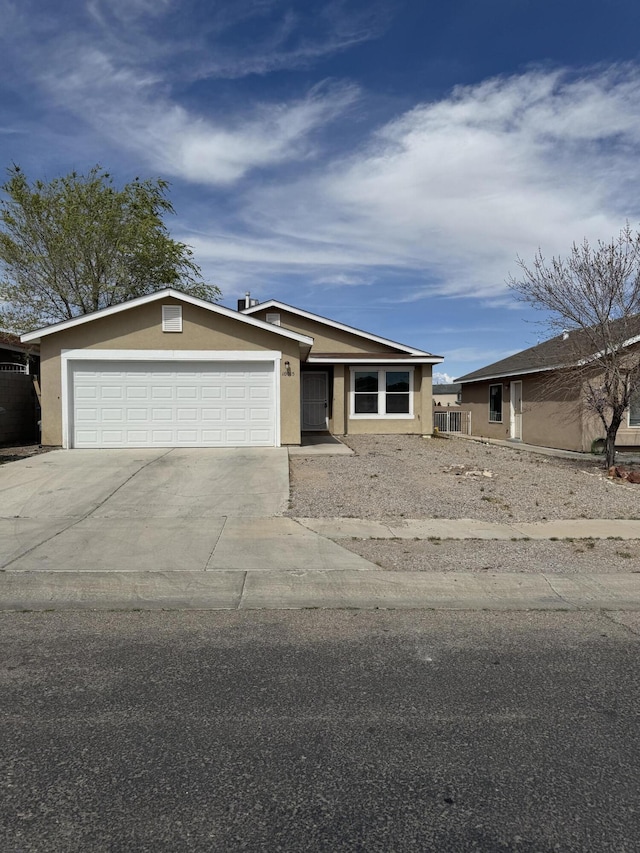 single story home featuring stucco siding, concrete driveway, and an attached garage