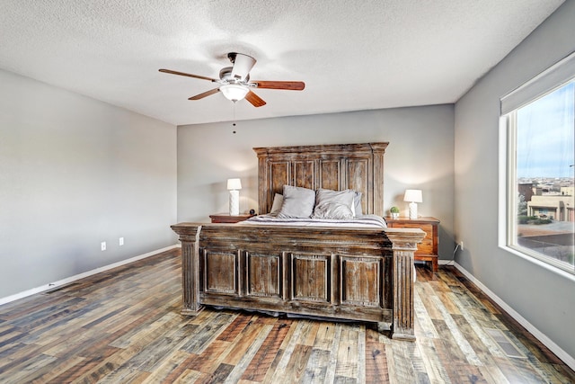 2467 Corvara Dr SE, Rio Rancho, NM 87124 - bedroom with wood finished floors, baseboards, a textured ceiling, and a ceiling fan