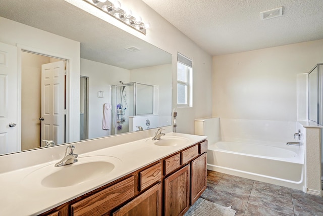 2467 Corvara Dr SE, Rio Rancho, NM 87124 - full bathroom with a garden tub, a shower stall, double vanity, and a textured ceiling