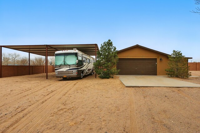 17 Frances Rd, Los Lunas, NM 87031 - view of front facade featuring driveway, a garage, and a carport
