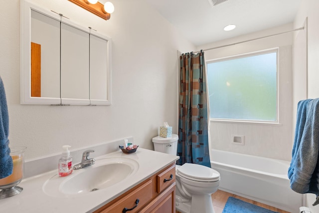 full bath with shower / tub combo, vanity, and toilet