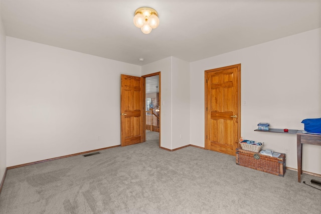 unfurnished bedroom with visible vents, baseboards, and carpet flooring