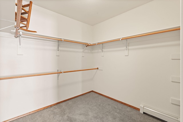 spacious closet with baseboard heating and carpet flooring