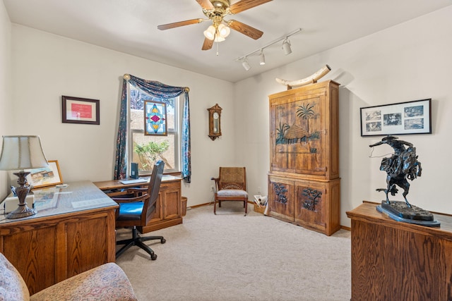 office featuring rail lighting, light colored carpet, baseboards, and a ceiling fan