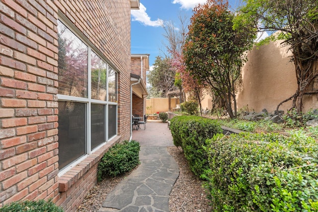 view of yard featuring fence and a patio