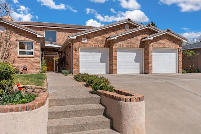 view of front facade with brick siding, driveway, and a garage