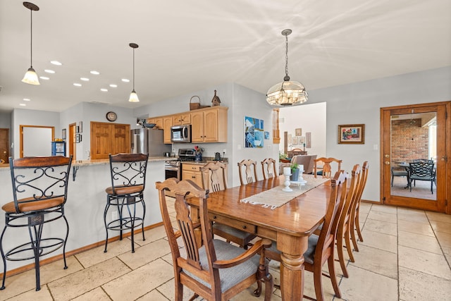 dining room with recessed lighting, a notable chandelier, baseboards, and stone tile flooring