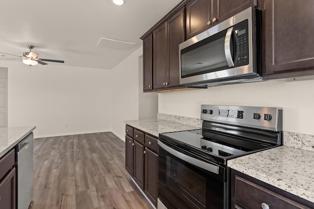 2522 Desi Loop, Belen, NM 87002 - kitchen featuring appliances with stainless steel finishes, dark brown cabinets, ceiling fan, wood finished floors, and baseboards