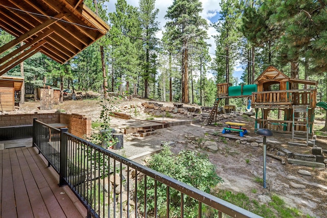 wooden terrace featuring a playground