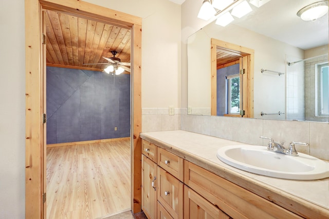 bathroom featuring wooden ceiling, backsplash, vanity, a ceiling fan, and wood finished floors