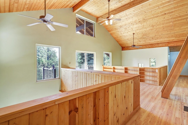 hall with an upstairs landing, high vaulted ceiling, light wood-style flooring, beamed ceiling, and wood ceiling