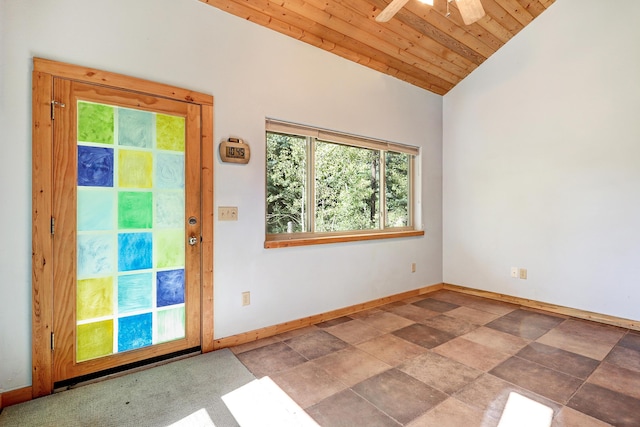 spare room featuring baseboards, lofted ceiling, wood ceiling, and a ceiling fan