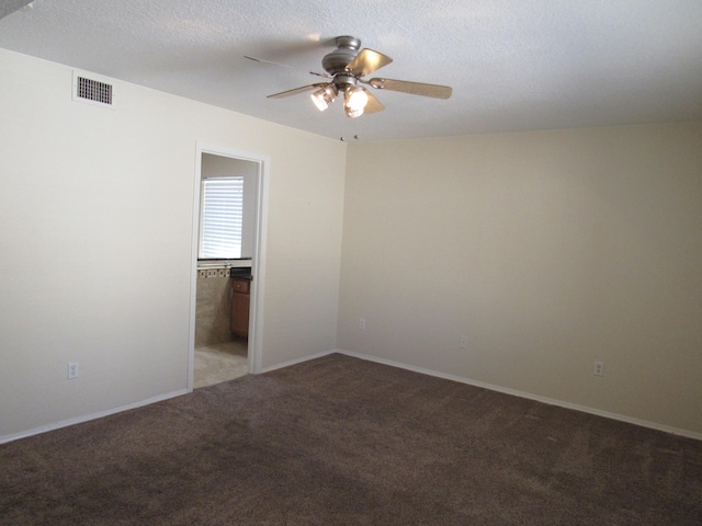 spare room with a ceiling fan, visible vents, light colored carpet, and baseboards