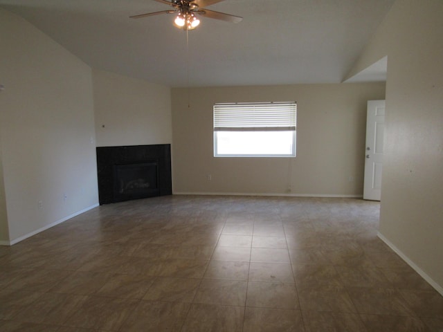 unfurnished living room featuring baseboards, a ceiling fan, lofted ceiling, and a fireplace