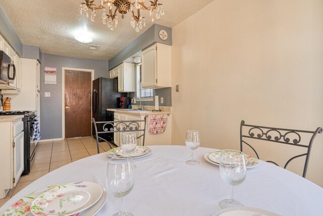 1706 Zickert Pl NW, Albuquerque, NM 87104 - dining space featuring a chandelier, a textured ceiling, light tile patterned floors, and baseboards
