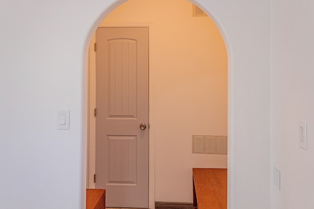 hall featuring arched walkways