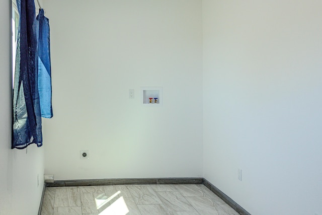 washroom with hookup for a washing machine, hookup for an electric dryer, laundry area, and baseboards