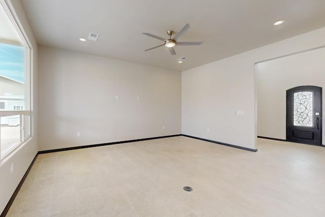 spare room with baseboards, recessed lighting, visible vents, and a ceiling fan