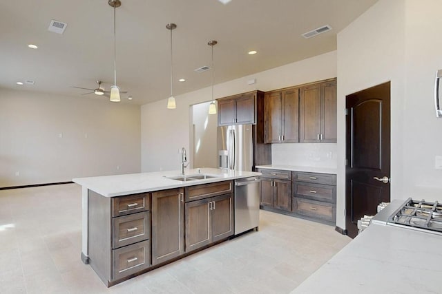 kitchen featuring a sink, stainless steel appliances, a ceiling fan, visible vents, and hanging light fixtures