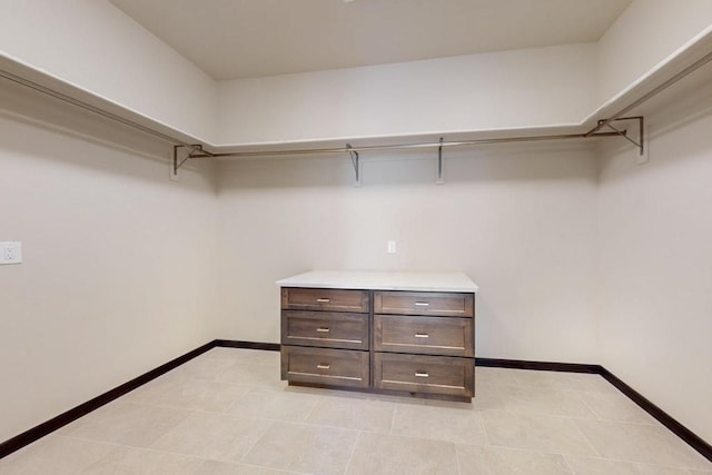 spacious closet with light tile patterned floors