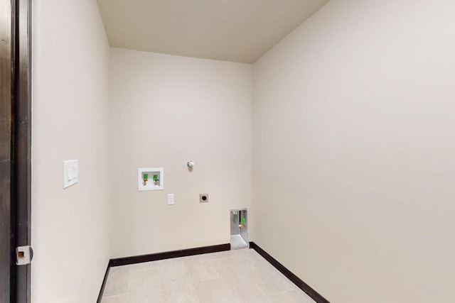 laundry area with laundry area, hookup for an electric dryer, hookup for a gas dryer, washer hookup, and baseboards