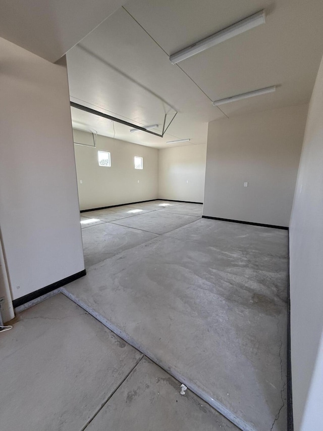 interior space with concrete flooring and baseboards