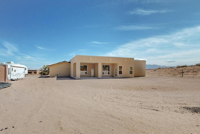back of house featuring stucco siding
