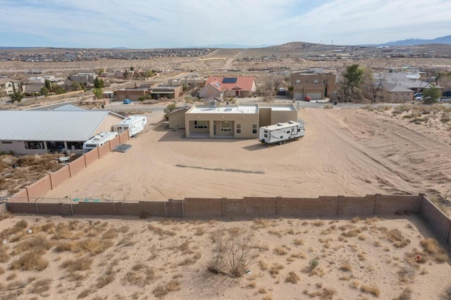 aerial view featuring a residential view, a mountain view, and a desert view