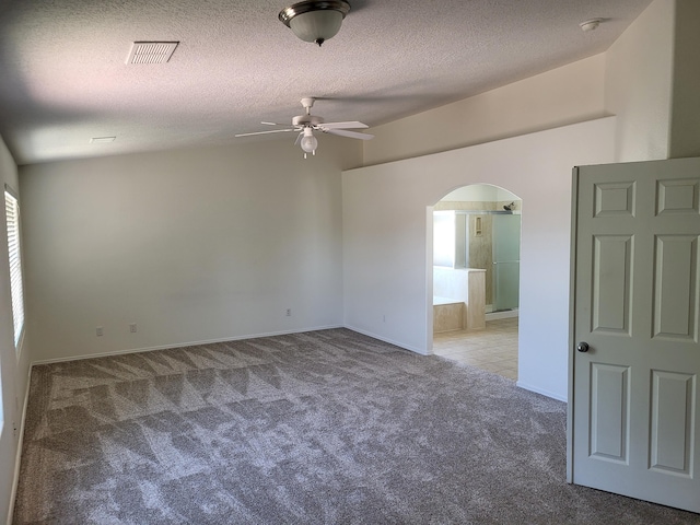 1511 White Pine Dr, Rio Rancho, NM 87144 - empty room featuring arched walkways, carpet, a ceiling fan, a textured ceiling, and a smoke detector