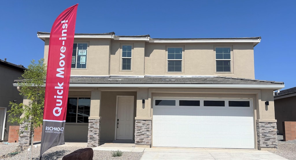 3217 Matador St SE, Rio Rancho, NM 87144 - view of front of property with stone siding, driveway, and stucco siding