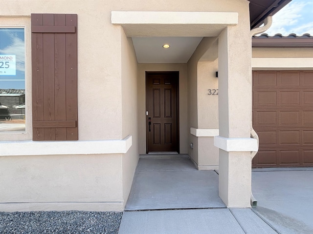 3225 Matador St SE, Rio Rancho, NM 87144 - property entrance featuring stucco siding and a garage