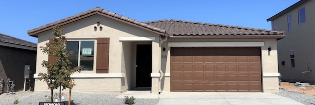 3225 Matador St SE, Rio Rancho, NM 87144 - view of front of property featuring driveway, an attached garage, stucco siding, and a tile roof