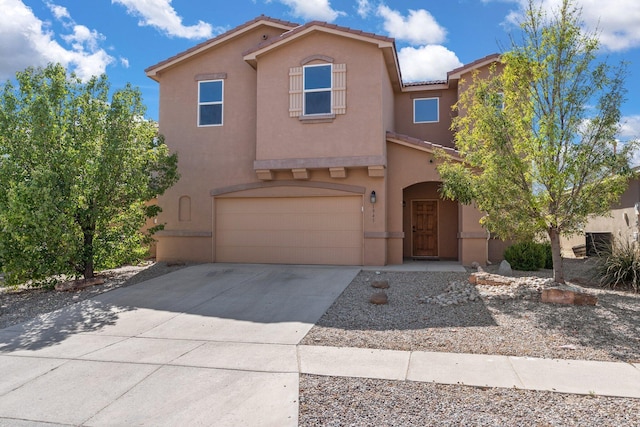 1941 Platina Rd SE, Rio Rancho, NM 87124 - mediterranean / spanish-style house featuring stucco siding, an attached garage, driveway, and a tiled roof