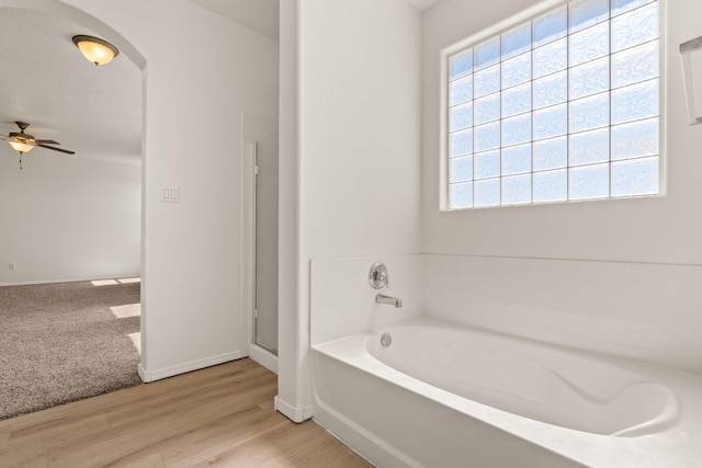 1941 Platina Rd SE, Rio Rancho, NM 87124 - bathroom with a shower stall, ceiling fan, a garden tub, and wood finished floors