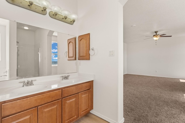 1941 Platina Rd SE, Rio Rancho, NM 87124 - bathroom featuring double vanity, walk in shower, a sink, and ceiling fan