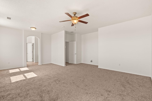 1941 Platina Rd SE, Rio Rancho, NM 87124 - unfurnished room featuring a ceiling fan, arched walkways, light colored carpet, baseboards, and visible vents