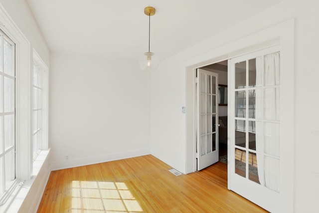 223 Edith Blvd SE, Albuquerque, NM 87102 - spare room with french doors, baseboards, light wood finished floors, and visible vents