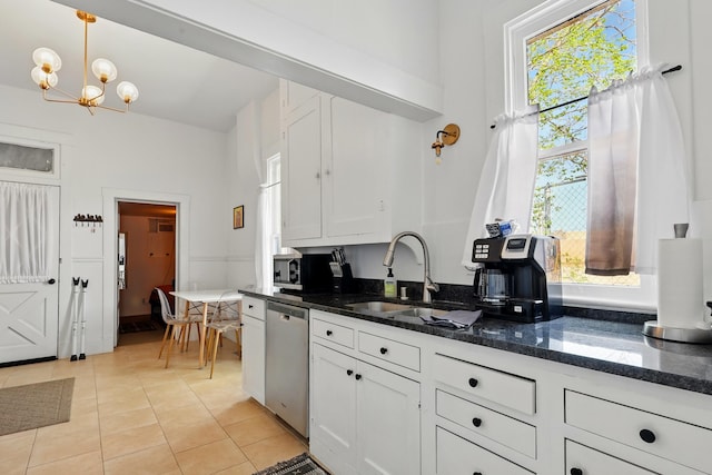 223 Edith Blvd SE, Albuquerque, NM 87102 - kitchen with white cabinetry, light tile patterned floors, a notable chandelier, and appliances with stainless steel finishes