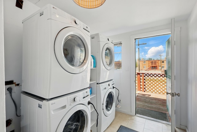223 Edith Blvd SE, Albuquerque, NM 87102 - washroom featuring stacked washer / drying machine, laundry area, and light tile patterned floors