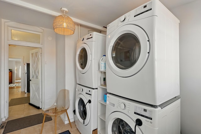 223 Edith Blvd SE, Albuquerque, NM 87102 - washroom featuring stacked washer / dryer, laundry area, and light tile patterned floors