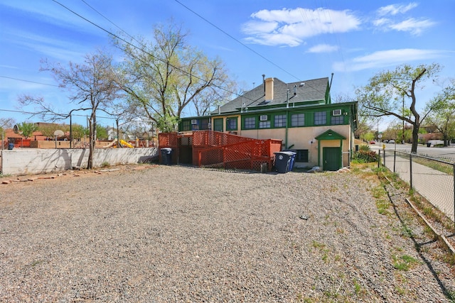 223 Edith Blvd SE, Albuquerque, NM 87102 - rear view of house with a wooden deck and fence