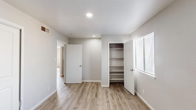 unfurnished bedroom featuring baseboards, visible vents, recessed lighting, and light wood-style floors