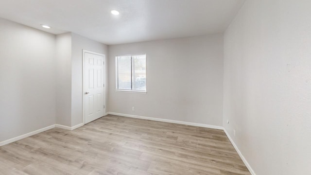 unfurnished room with recessed lighting, light wood-style floors, and baseboards