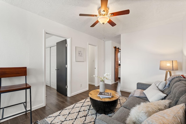 920 Spur Pl SE, Rio Rancho, NM 87124 - living room featuring a textured ceiling, wood finished floors, baseboards, and a ceiling fan