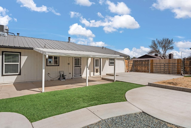 920 Spur Pl SE, Rio Rancho, NM 87124 - rear view of house with a yard, metal roof, fence, and a patio