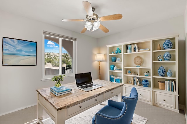 home office with a ceiling fan and baseboards
